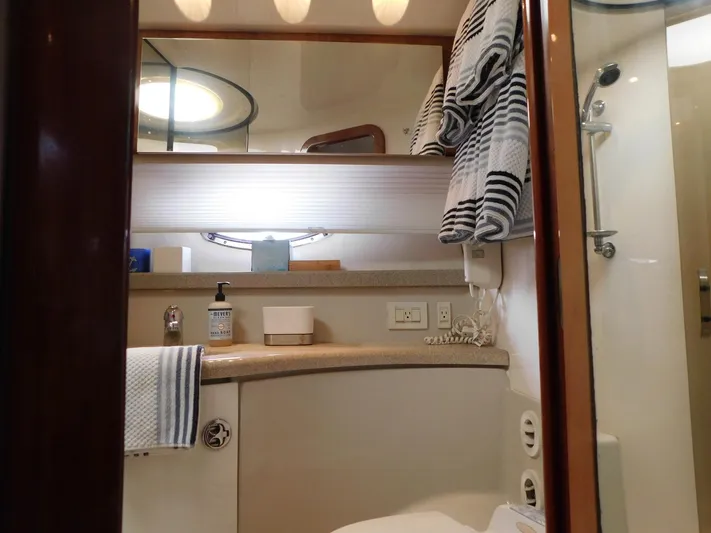 Sea Y'all Yacht Photos Pics Bathroom interior of 2004 Regal Commodore 3860 yacht with towels and toiletries.