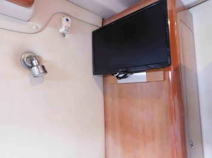 Sea Y'all Yacht Photos Pics 2004 Regal Commodore 3860 interior with mounted TV and wall light fixture.