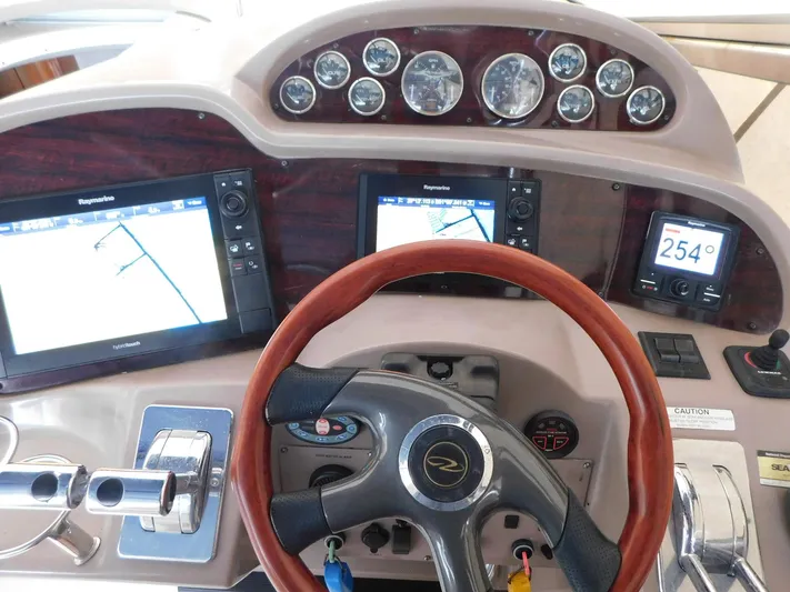 Sea Y'all Yacht Photos Pics Dashboard of a 2004 Regal Commodore 3860 boat with navigation screens and gauges.