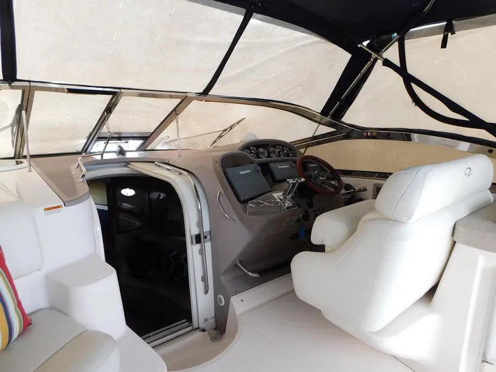 Sea Y'all Yacht Photos Pics 2004 Regal Commodore 3860 yacht interior with helm, white seating, and navigation equipment.