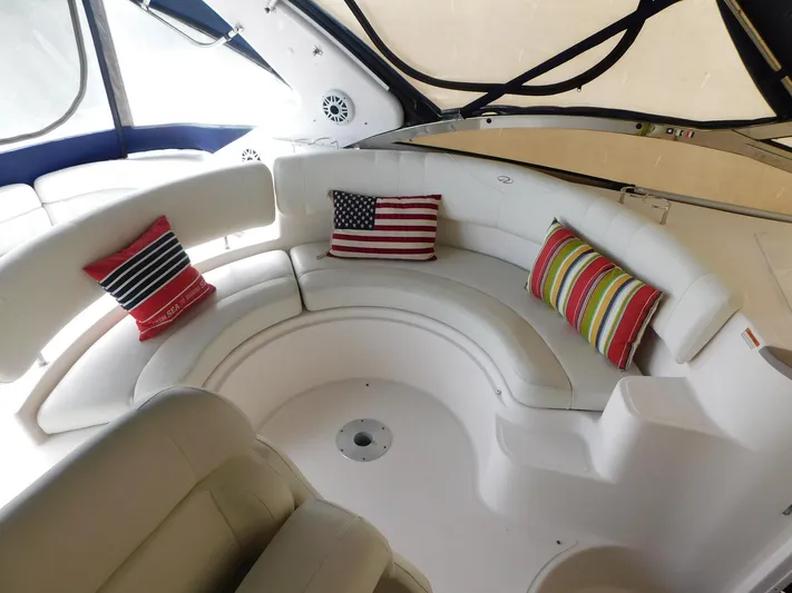 Sea Y'all Yacht Photos Pics 2004 Regal Commodore 3860 yacht interior with curved seating and decorative pillows.