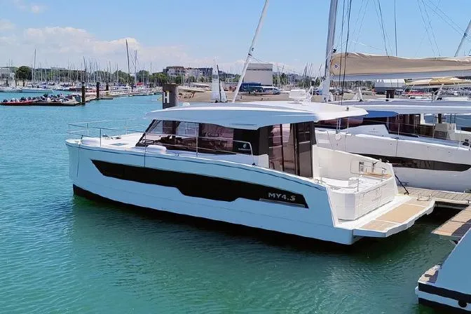  Yacht Photos Pics 2025 Fountaine Pajot MY4.S yacht docked in a marina under clear skies.