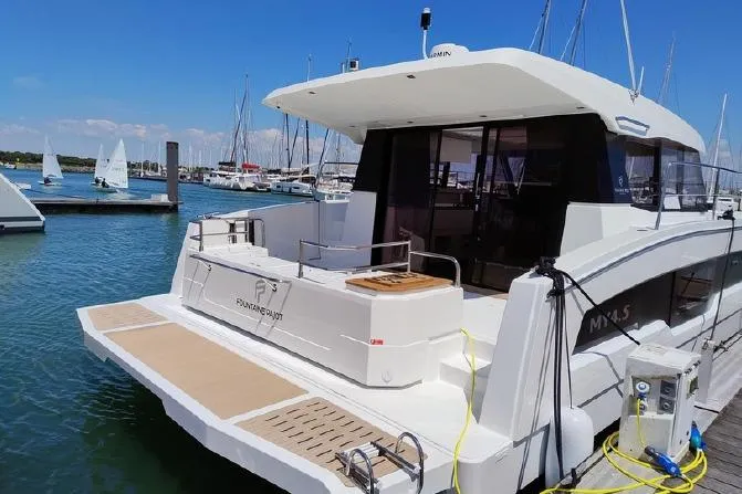  Yacht Photos Pics 2025 Fountaine Pajot MY4.S yacht docked at marina, showcasing sleek design and spacious deck.