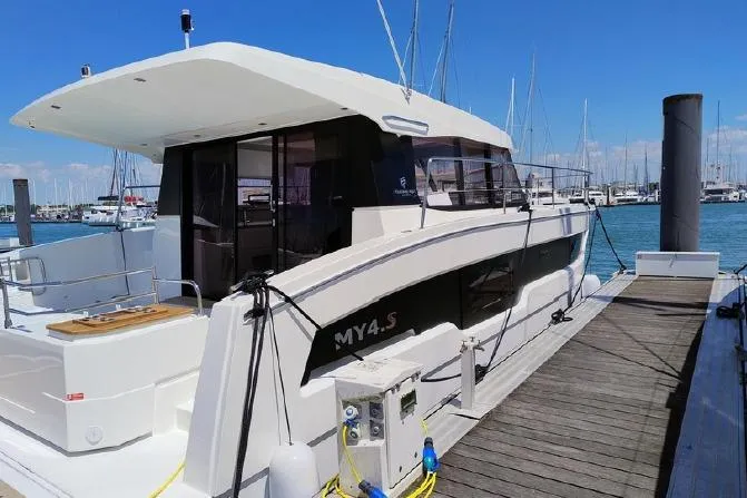  Yacht Photos Pics 2025 Fountaine Pajot MY4.S yacht docked at marina under clear blue sky.