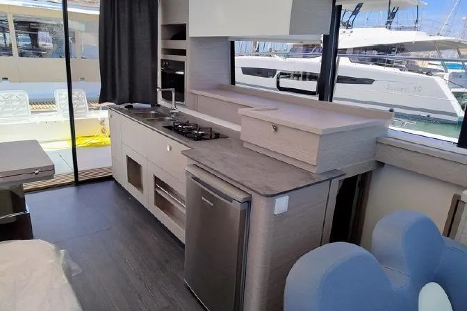  Yacht Photos Pics Modern kitchen interior of 2025 Fountaine Pajot MY4.S yacht with sleek design and appliances.
