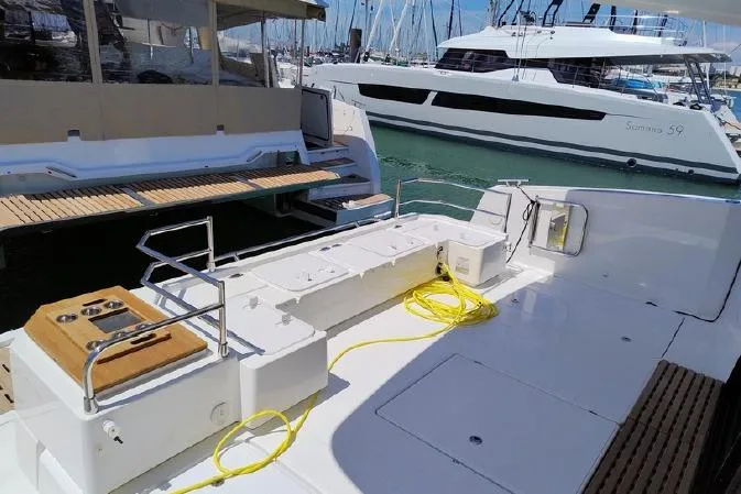  Yacht Photos Pics 2025 Fountaine Pajot MY4.S yacht deck with marina view, featuring modern design and amenities.