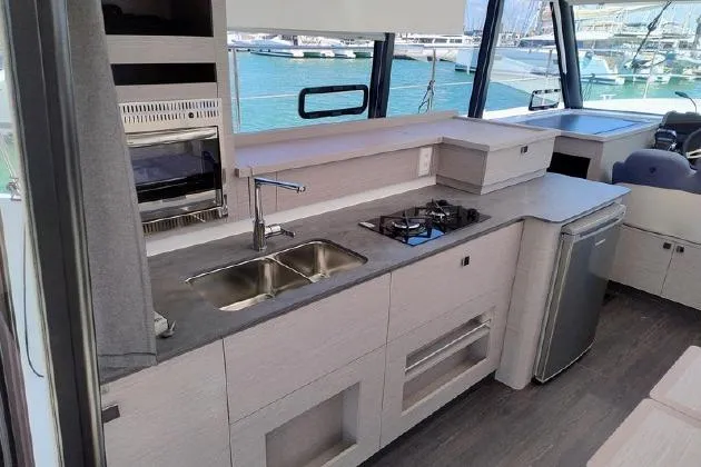  Yacht Photos Pics Modern kitchen interior of 2025 Fountaine Pajot MY4.S yacht with sleek design and appliances.