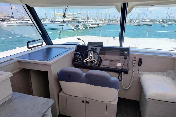  Yacht Photos Pics Helm station of 2025 Fountaine Pajot MY4.S yacht with marina view.