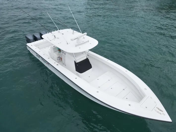 Last Resort Yacht Photos Pics 2013 Bahama Open Fisherman boat on water, featuring triple outboard motors.