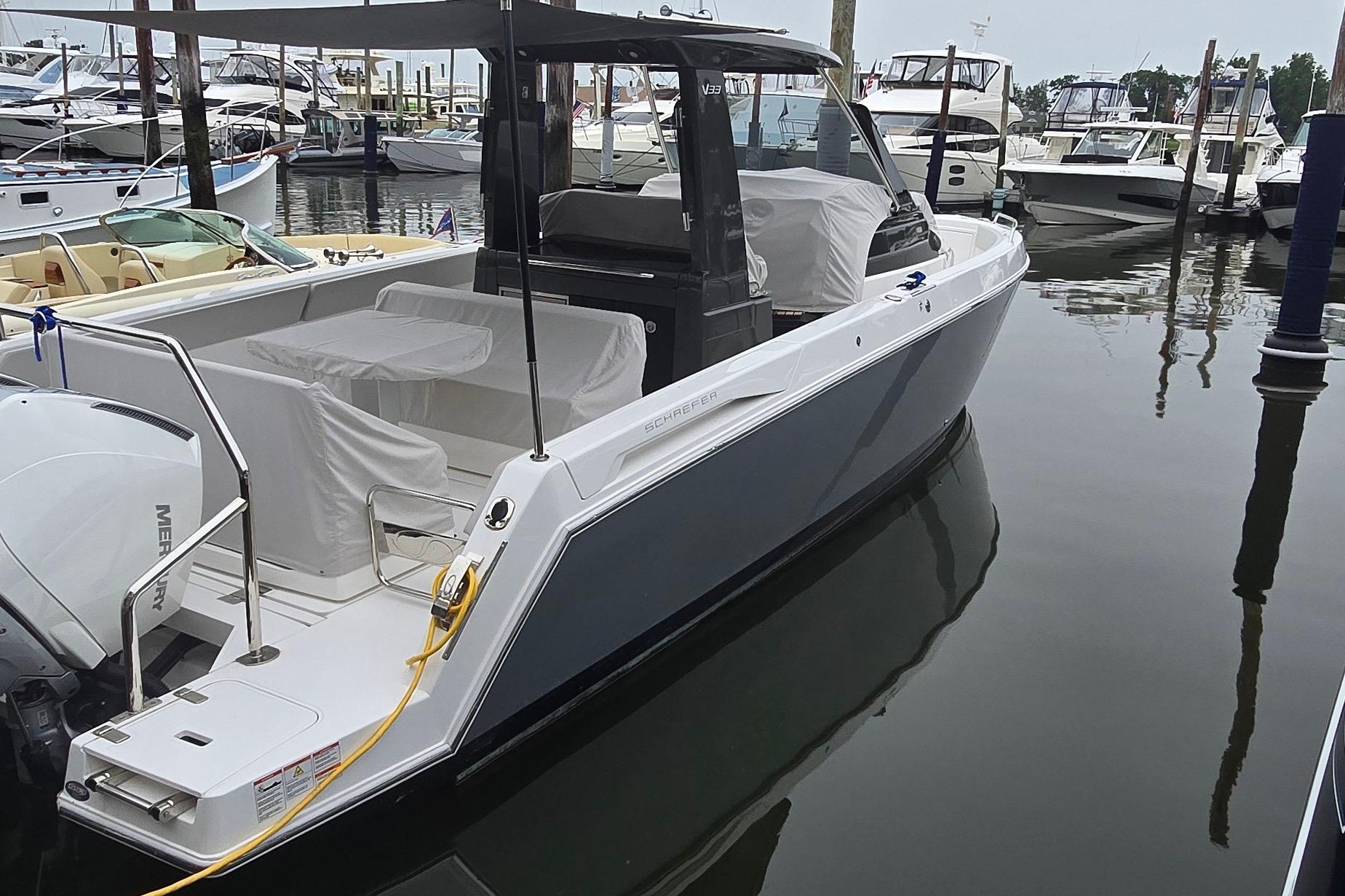 2025 Schaefer V33 boat docked in marina, featuring sleek design and modern amenities.