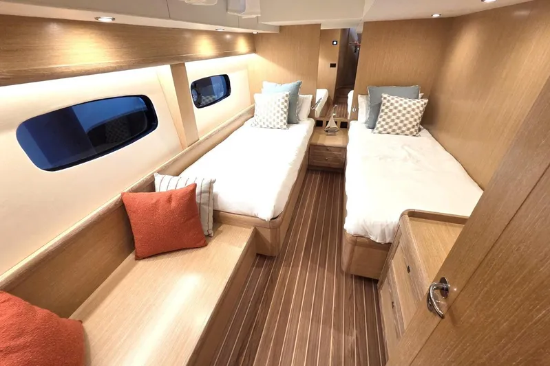 Menorquin 48 Fly Yacht Photos Pics Luxurious cabin interior of 2026 Sasga Yachts Menorquin 48 with twin beds and elegant wood finish.