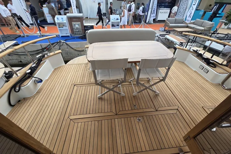 Menorquin 48 Fly Yacht Photos Pics Deck of 2026 Sasga Yachts Menorquin 48 with table and chairs, showcasing elegant design.