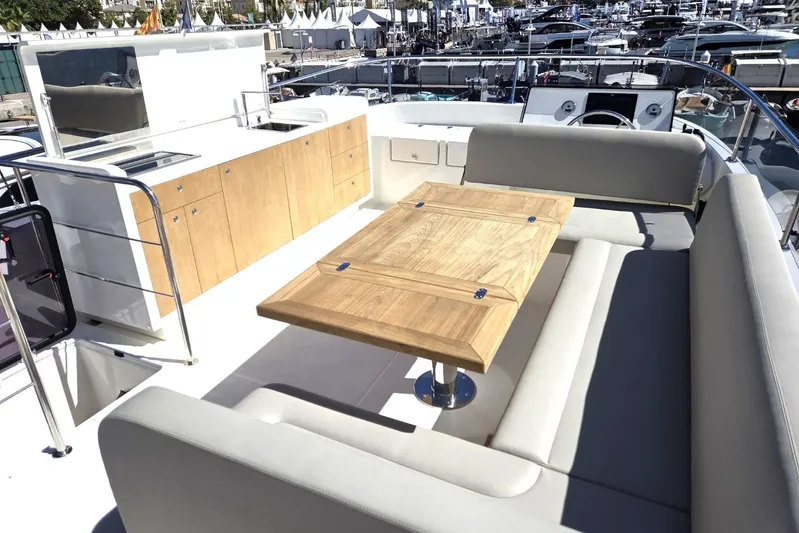 Menorquin 48 Fly Yacht Photos Pics Luxurious 2026 Sasga Yachts Menorquin 48 with elegant outdoor seating and dining area.