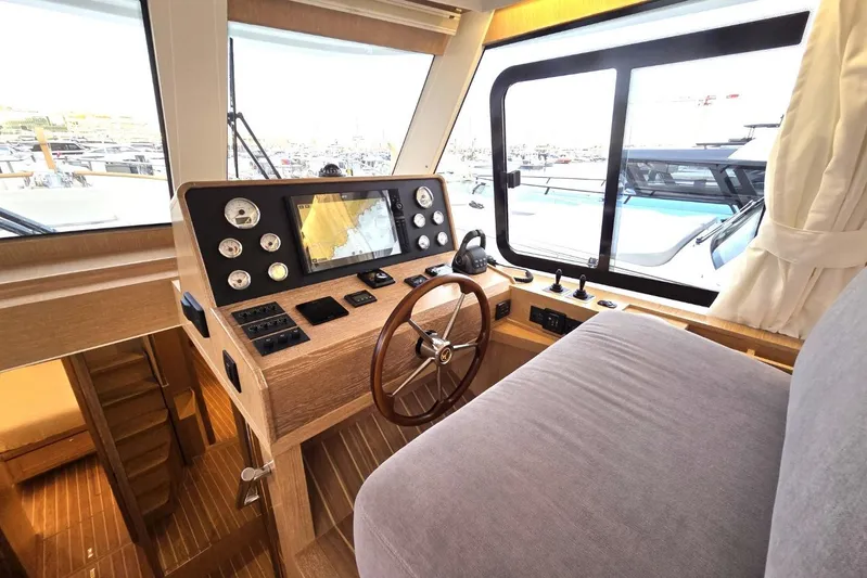 Menorquin 48 Fly Yacht Photos Pics 2026 Sasga Yachts Menorquin 48 helm with wooden steering wheel and navigation instruments.