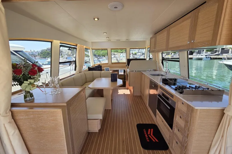 Menorquin 48 Fly Yacht Photos Pics Luxurious interior of 2026 Sasga Yachts Menorquin 48 with modern kitchen and seating area.