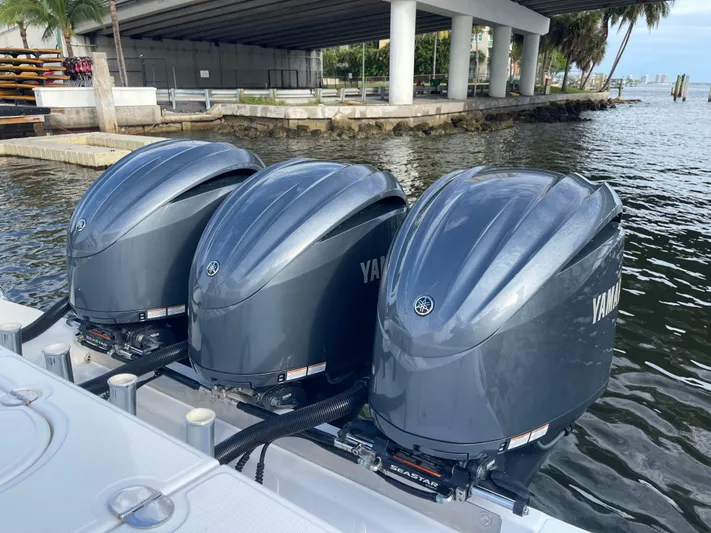 Last Resort Yacht Photos Pics Triple Yamaha outboard engines on a 2013 Bahama Open Fisherman boat by the water.