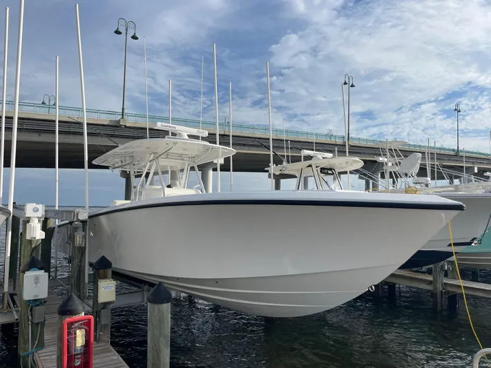 Last Resort Yacht Photos Pics 2013 Bahama Open Fisherman boat docked under a bridge on a sunny day.