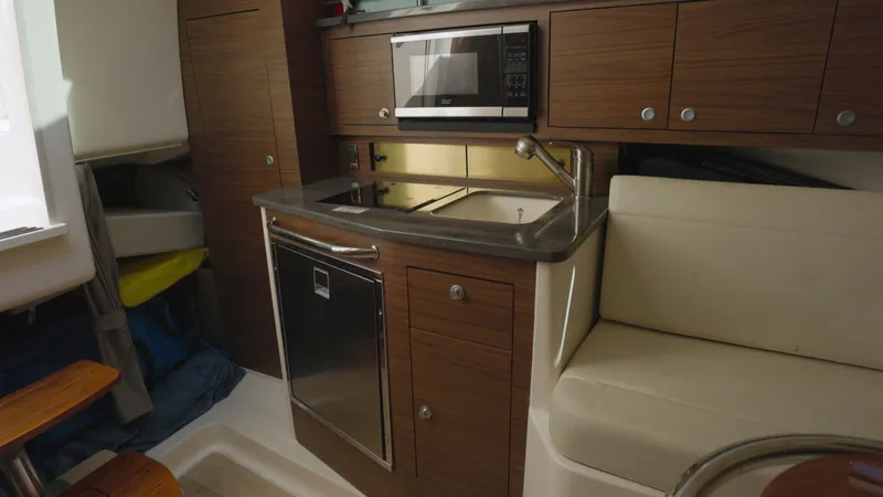 Salt Yacht Photos Pics Interior of 2023 Boston Whaler 325 Conquest with kitchenette and seating area.