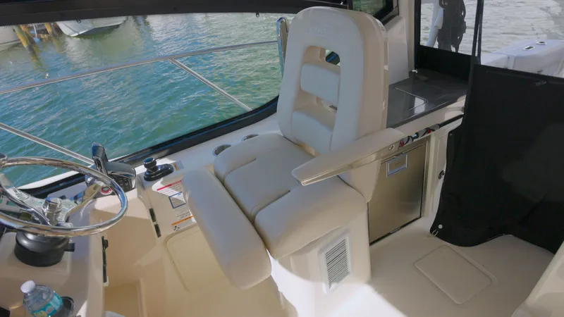 Salt Yacht Photos Pics Interior of 2023 Boston Whaler 325 Conquest with steering wheel and seat.