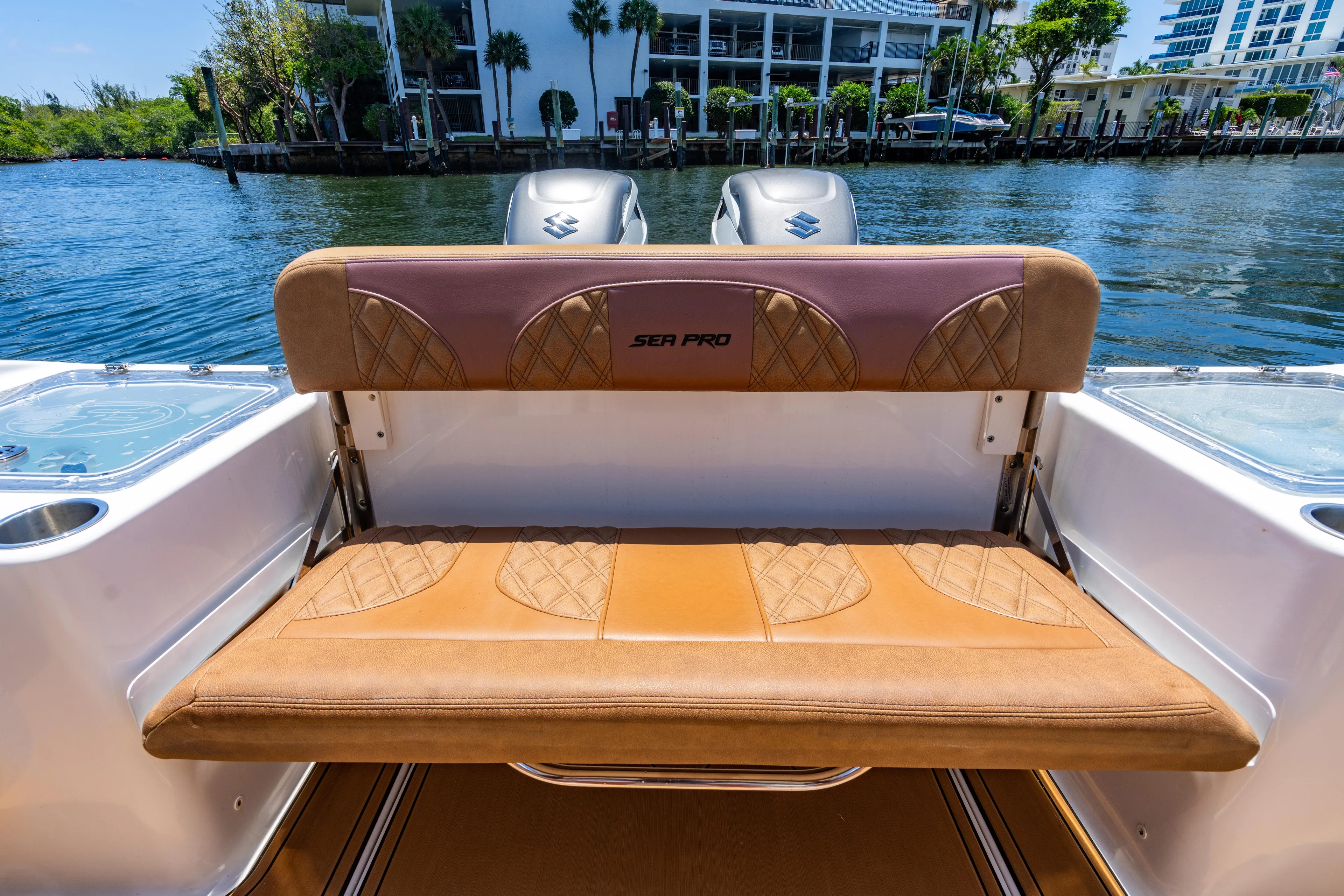  Yacht Photos Pics 2023 Sea Pro 320 DLX Offshore boat with tan seating, docked by the water.