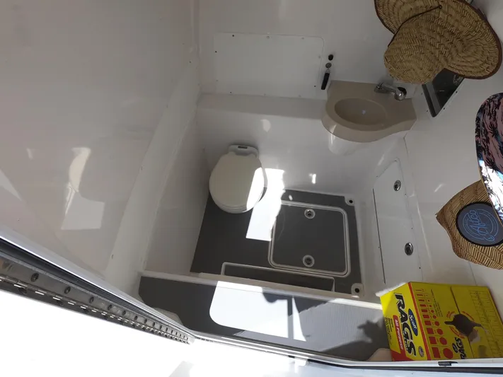  Yacht Photos Pics Compact bathroom in 2019 Invincible 39 CC boat, featuring toilet and sink.