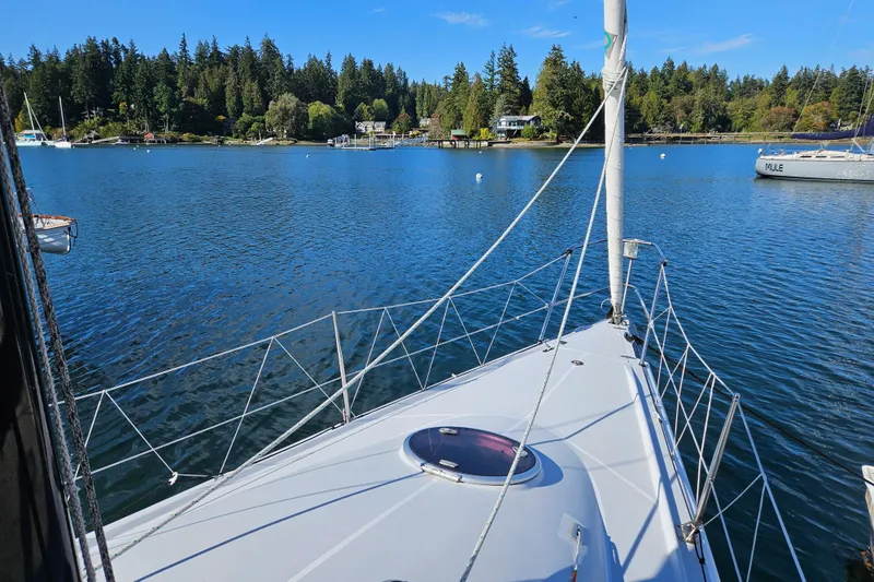 Ace Yacht Photos Pics Sailboat Farr 395 (2001) on calm water with scenic forested shoreline.
