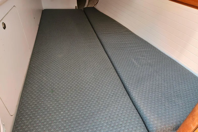 Ace Yacht Photos Pics Interior cabin view of a 2001 Farr 395 sailboat with cushioned seating.