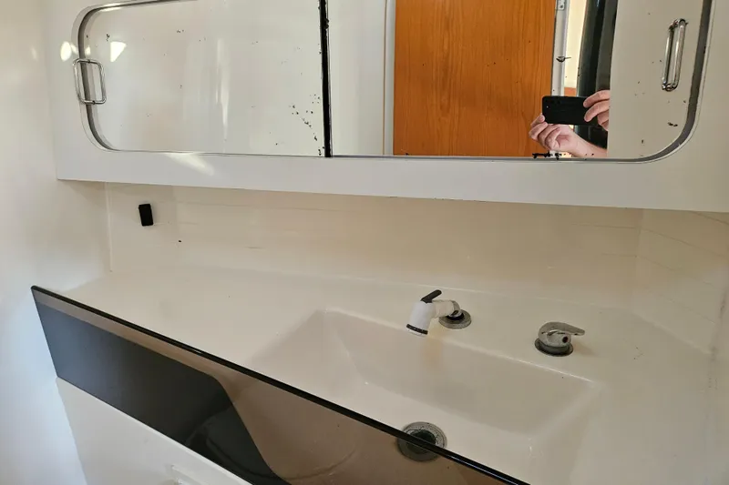 Ace Yacht Photos Pics Bathroom sink and mirror in a 2001 Farr 395 yacht.