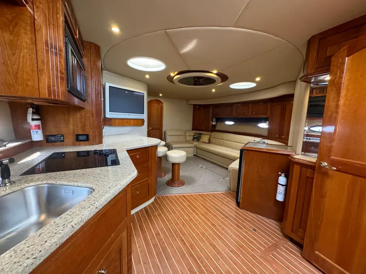  Yacht Photos Pics Luxurious interior of 2003 Cruisers Yachts 540 Express with modern kitchen and cozy seating area.