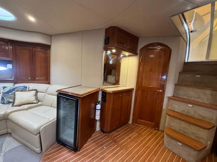  Yacht Photos Pics Luxurious interior of 2003 Cruisers Yachts 540 Express with leather seating and wooden cabinetry.