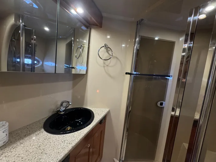  Yacht Photos Pics Luxurious bathroom in 2003 Cruisers Yachts 540 Express with sleek fixtures and modern design.