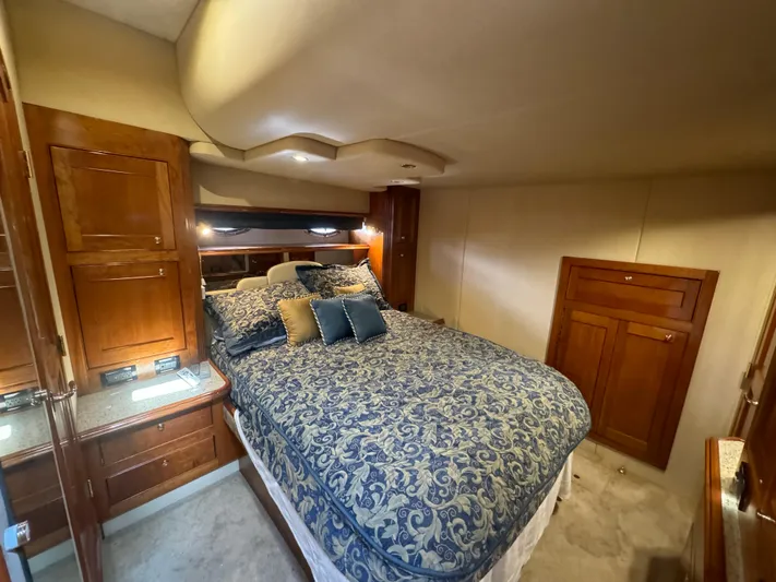  Yacht Photos Pics Luxurious bedroom interior of 2003 Cruisers Yachts 540 Express with elegant bedding and wood cabinetry.