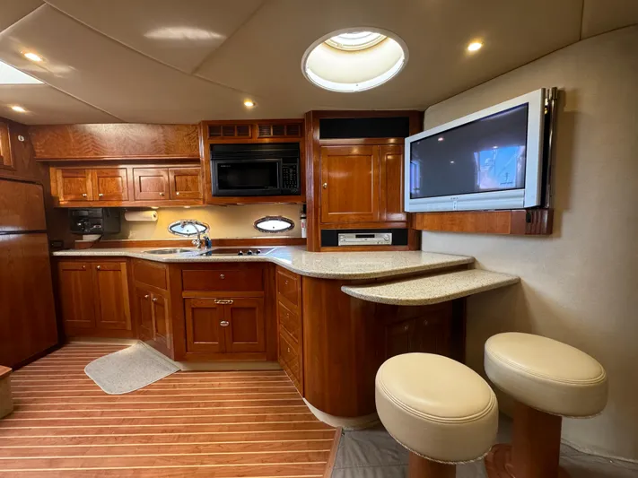  Yacht Photos Pics Luxurious 2003 Cruisers Yachts 540 Express interior with wood cabinetry and modern amenities.
