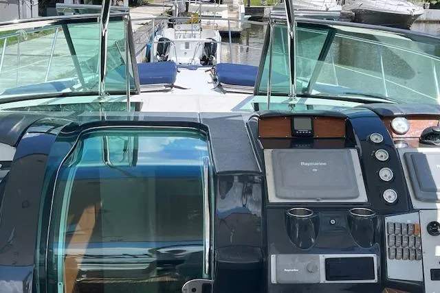  Yacht Photos Pics 2008 Doral Medditerra yacht cockpit with navigation controls and glass canopy in marina setting.