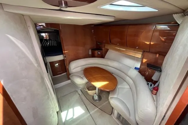  Yacht Photos Pics 2008 Doral Medditerra yacht interior with curved seating and wooden table.