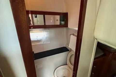  Yacht Photos Pics 2008 Doral Medditerra boat bathroom with wooden cabinets and white fixtures.