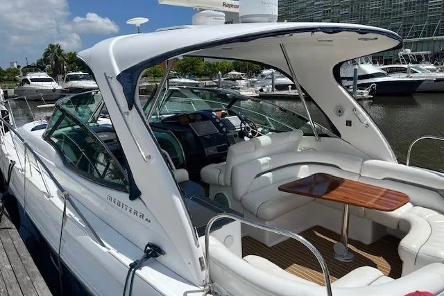  Yacht Photos Pics 2008 Doral Medditerra yacht with sleek design, docked at marina under clear blue sky.