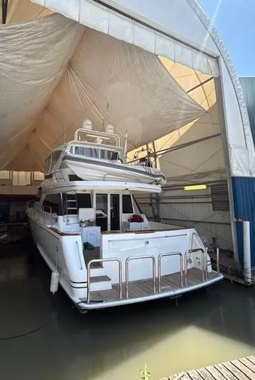  Yacht Photos Pics 2001 West Bay Sonship 58 Pilothouse yacht docked in a covered marina.