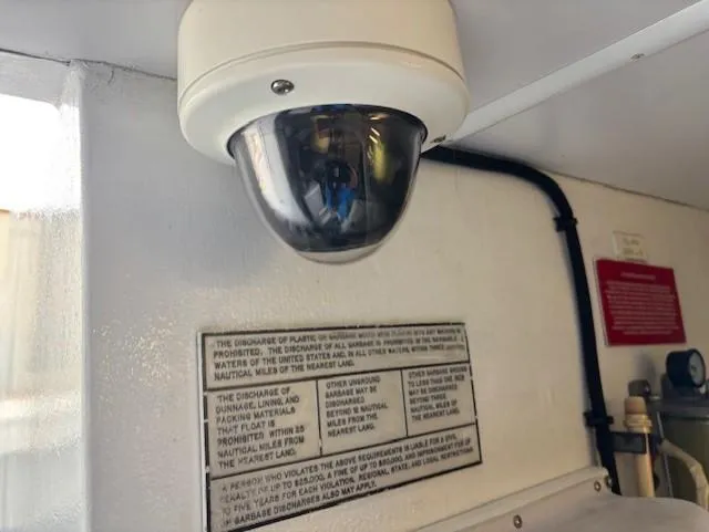  Yacht Photos Pics Security camera inside 2001 West Bay Sonship 58 Pilothouse, with safety instructions visible.