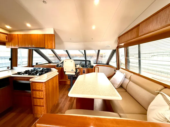  Yacht Photos Pics Luxurious 2001 West Bay Sonship 58 Pilothouse interior with modern kitchen and dining area.