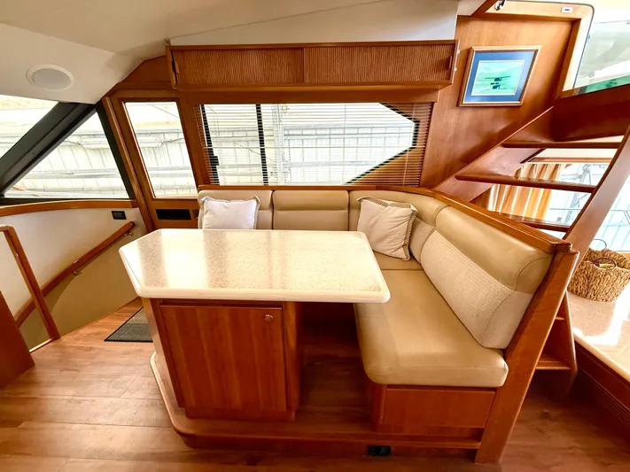  Yacht Photos Pics Luxurious interior of 2001 West Bay Sonship 58 Pilothouse with elegant dining area and wooden finishes.