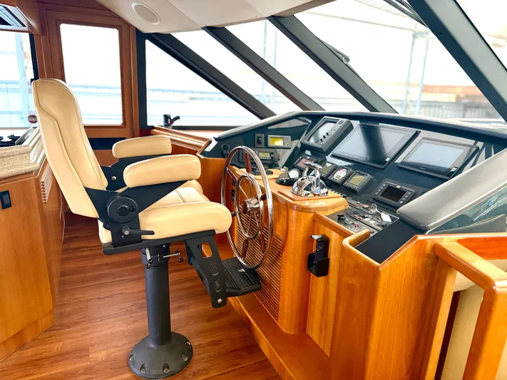  Yacht Photos Pics Pilothouse interior of 2001 West Bay Sonship 58, featuring helm station and captain's chair.