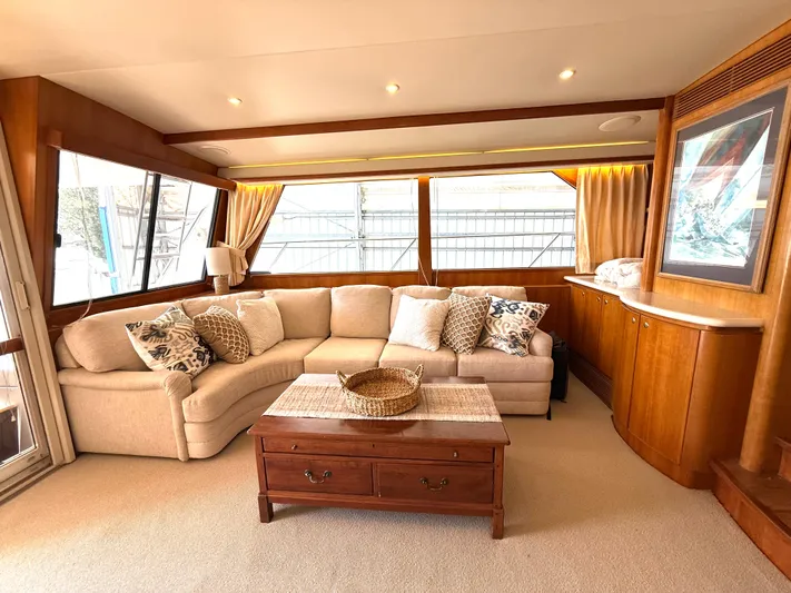  Yacht Photos Pics Luxurious 2001 West Bay Sonship 58 Pilothouse interior with elegant sofa and wooden accents.