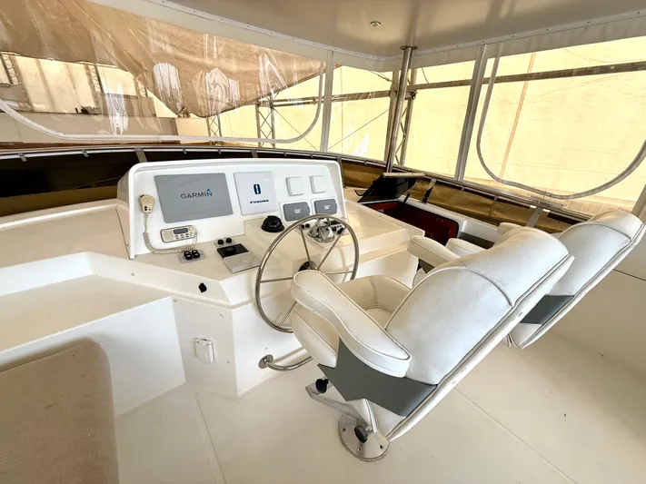  Yacht Photos Pics Pilothouse of 2001 West Bay Sonship 58, featuring dual captain chairs and navigation equipment.