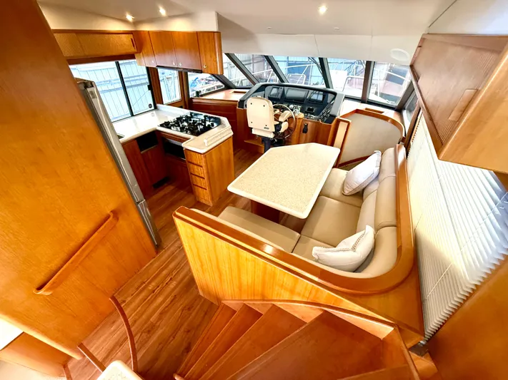  Yacht Photos Pics Luxurious interior of 2001 West Bay Sonship 58 Pilothouse yacht with wood finishes and modern amenities.