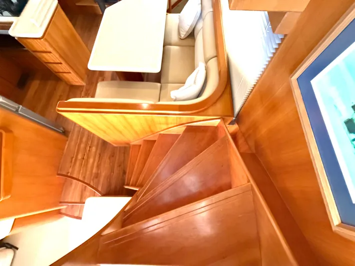  Yacht Photos Pics Interior of 2001 West Bay Sonship 58 Pilothouse with wooden stairs and dining area.