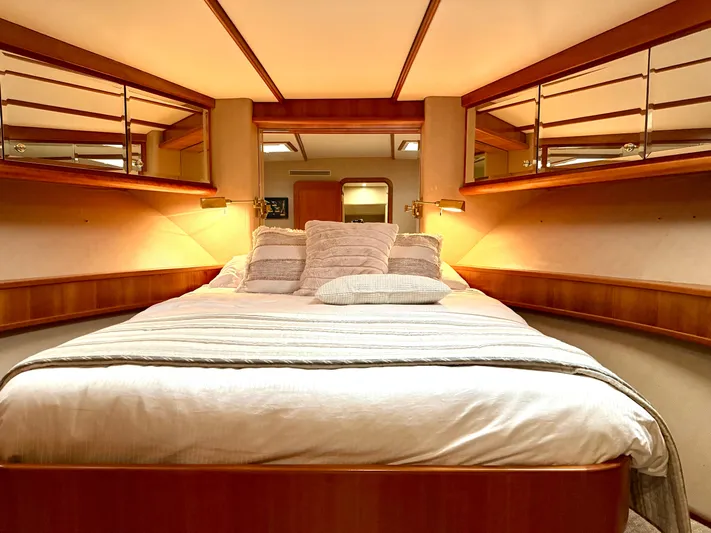 Yacht Photos Pics Luxurious bedroom interior of 2001 West Bay Sonship 58 Pilothouse yacht, featuring elegant wood accents.