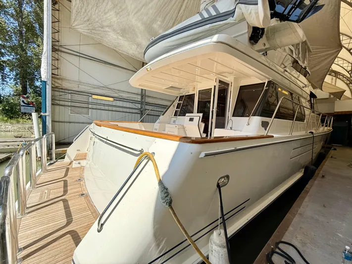  Yacht Photos Pics 2001 West Bay Sonship 58 Pilothouse yacht docked in a covered marina.