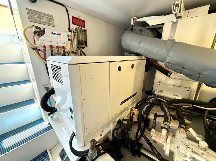  Yacht Photos Pics Engine room of 2001 West Bay Sonship 58 Pilothouse with generator and equipment.