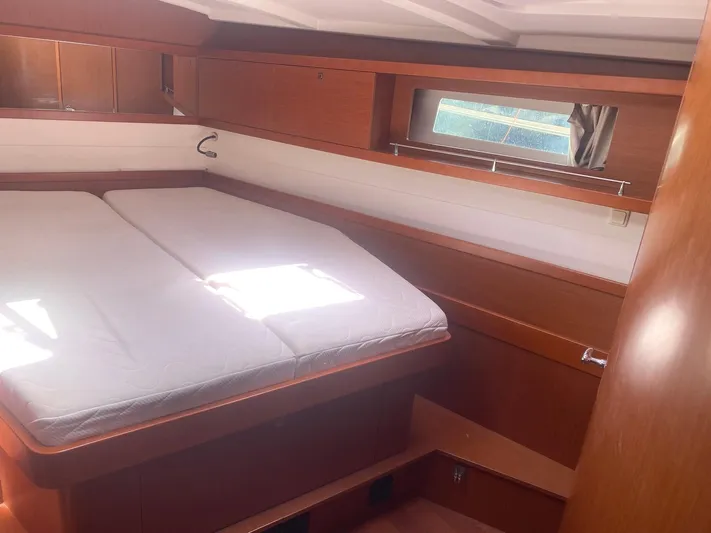  Yacht Photos Pics 2014 Beneteau Oceanis 45 cabin interior with bed and wooden finish.